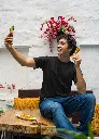 mockup-of-a-man-in-a-gildan-tee-taking-a-selfie-of-him-with-a-street-food-snack-m30296.webp