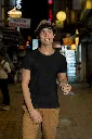 gildan-t-shirt-mockup-of-a-man-walking-with-a-drink-on-a-street-m30319.webp