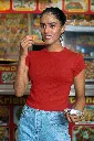 gildan-t-shirt-mockup-of-a-smiling-woman-eating-indian-food-on-the-street-m30330.webp