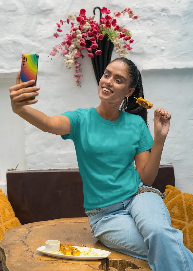 gildan-t-shirt-mockup-of-a-happy-woman-taking-a-selfie-and-eating-indian-food-m30294 (1).webp
