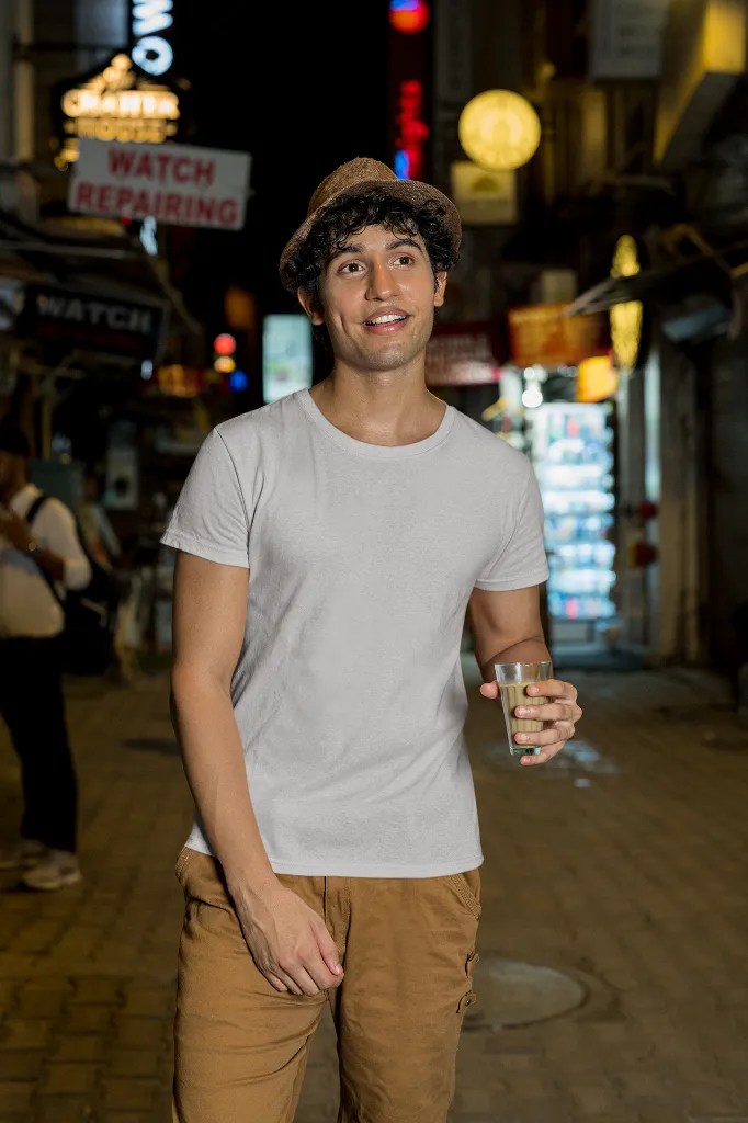 gildan-t-shirt-mockup-of-a-man-walking-with-a-drink-on-a-street-m30319 (4).webp