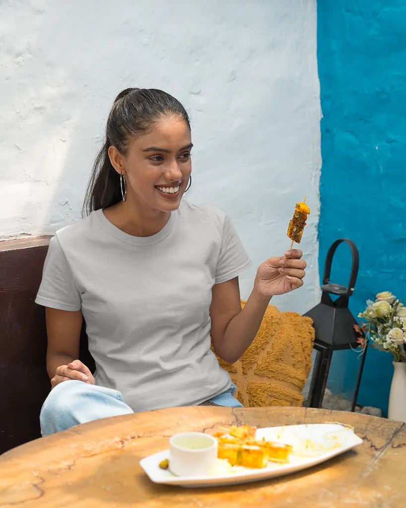 gildan-t-shirt-mockup-featuring-a-smiling-woman-eating-street-indian-food-m30293 (4).webp