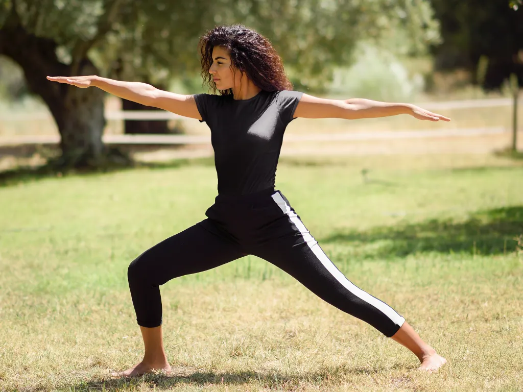 t-shirt-mockup-of-a-woman-doing-a-warrior-two-pose-in-nature-37627-r-el2 (1).webp