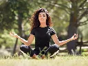 t-shirt-mockup-of-a-young-woman-with-curly-hair-meditating-in-the-park-35285-r-el2 (1).webp