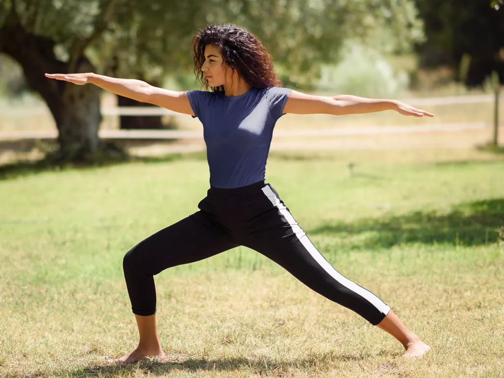 t-shirt-mockup-of-a-woman-doing-a-warrior-two-pose-in-nature-37627-r-el2 (2).webp