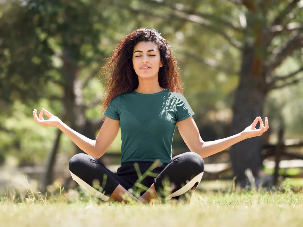 t-shirt-mockup-of-a-young-woman-with-curly-hair-meditating-in-the-park-35285-r-el2 (4).webp