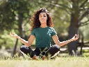 t-shirt-mockup-of-a-young-woman-with-curly-hair-meditating-in-the-park-35285-r-el2 (4).webp